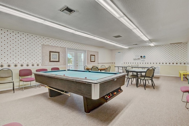 game room featuring a textured ceiling, light colored carpet, french doors, and billiards