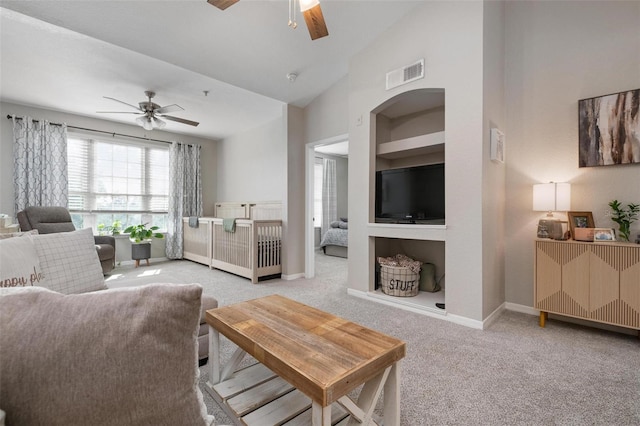 carpeted living room featuring ceiling fan and vaulted ceiling