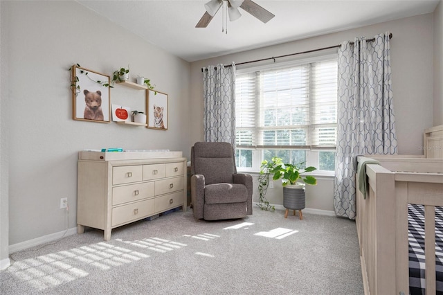 living area featuring light carpet and ceiling fan