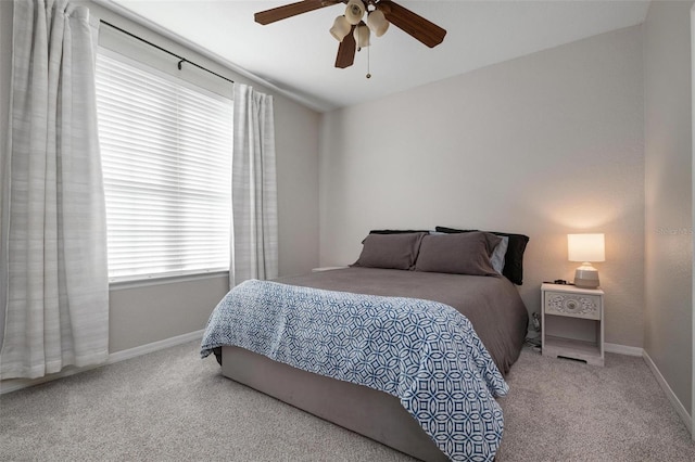 carpeted bedroom with ceiling fan and vaulted ceiling