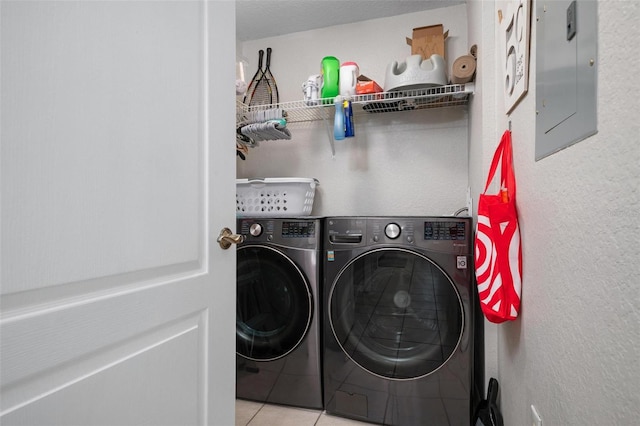 clothes washing area with light tile patterned floors, electric panel, and separate washer and dryer