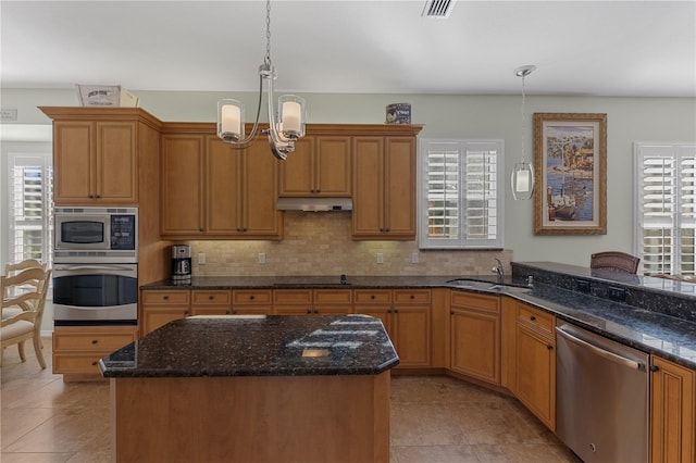 kitchen featuring pendant lighting, sink, a healthy amount of sunlight, and stainless steel appliances