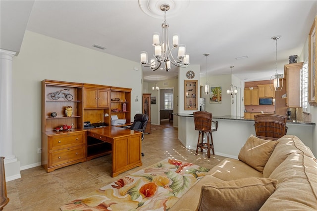 office space featuring a chandelier, light tile patterned floors, and decorative columns