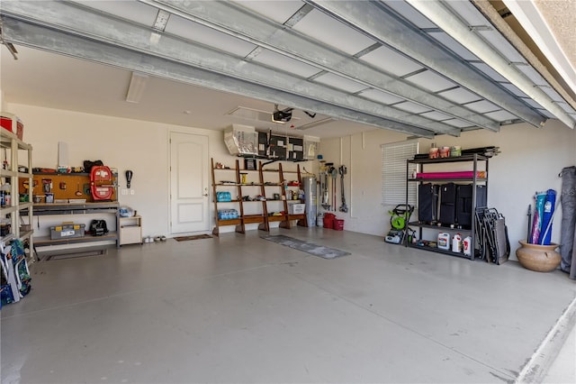 garage featuring electric water heater and a garage door opener