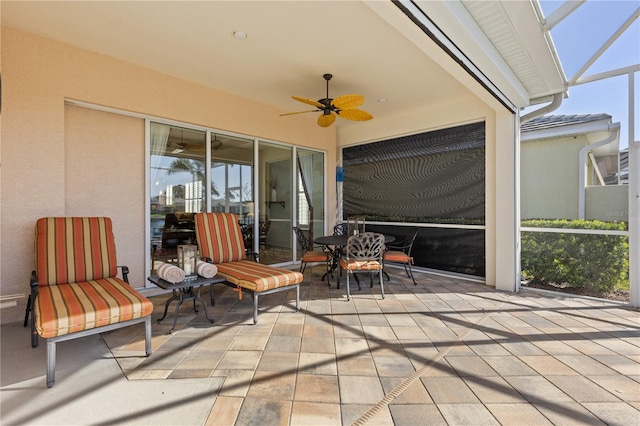 view of patio / terrace featuring a lanai and ceiling fan