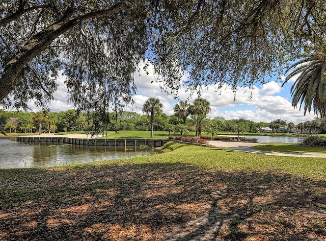 surrounding community with a yard and a water view