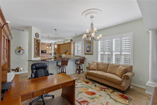 office area featuring visible vents, a chandelier, decorative columns, and baseboards