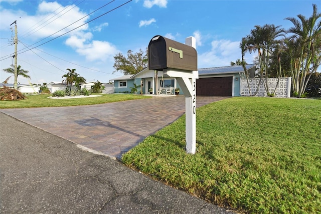 view of front of house with a front yard and a garage