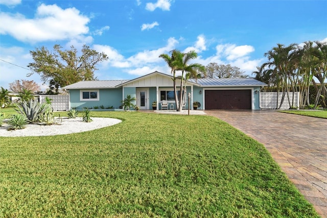 ranch-style home with a porch, a garage, and a front yard