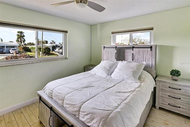 bedroom featuring light hardwood / wood-style floors and ceiling fan