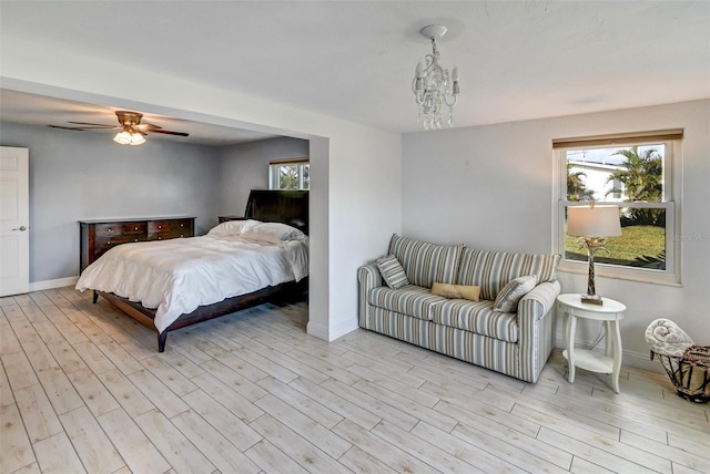 bedroom featuring light hardwood / wood-style flooring and a notable chandelier