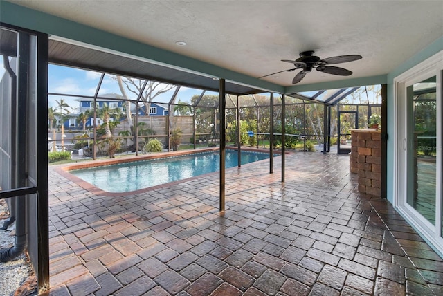 view of pool with a lanai, a patio area, and ceiling fan