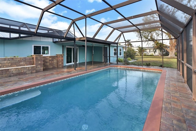 view of pool with a patio, ceiling fan, and a lanai