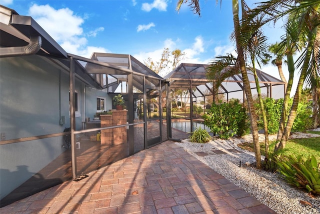 view of patio featuring glass enclosure