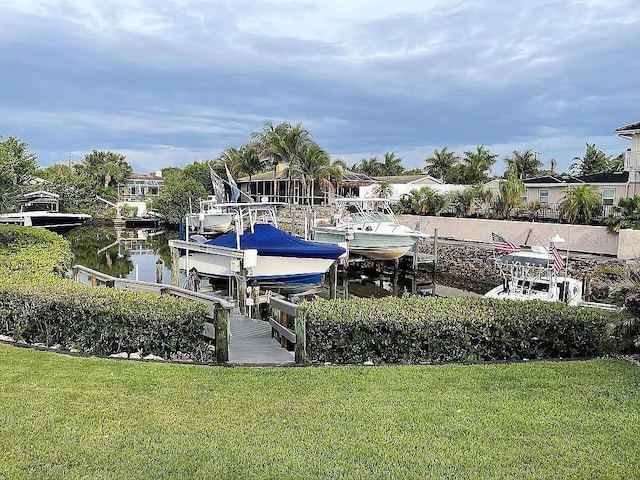 view of dock featuring a water view and a lawn