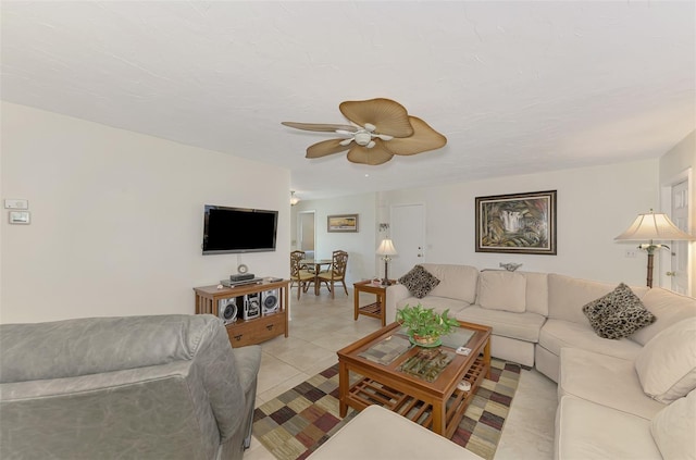 tiled living room featuring ceiling fan