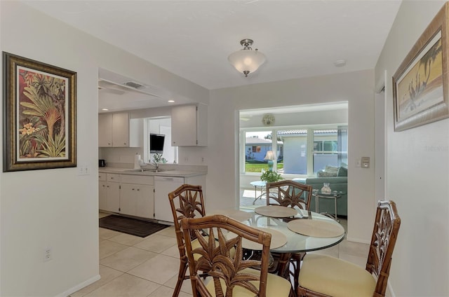 tiled dining space featuring sink