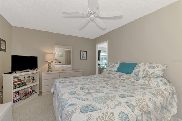 carpeted bedroom with a textured ceiling and ceiling fan