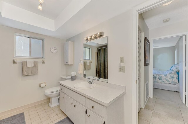 bathroom with vanity, toilet, and tile patterned flooring