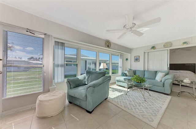 sunroom / solarium featuring ceiling fan