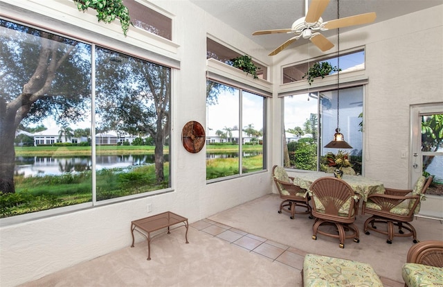 649 Crossfield Cir Unit 10, Venice, FL 34293 - sunroom / solarium featuring a water view, tile patterned flooring, a textured wall, and carpet flooring