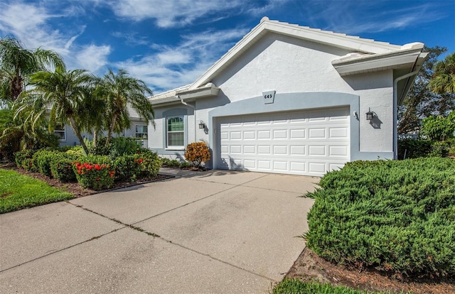 649 Crossfield Cir Unit 10, Venice, FL 34293 - view of front of home featuring stucco siding, an attached garage, and driveway