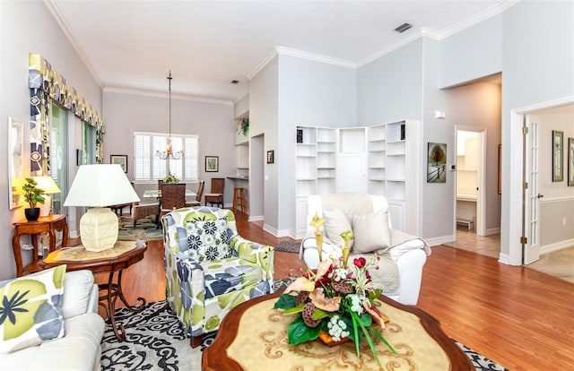 649 Crossfield Cir Unit 10, Venice, FL 34293 - living area featuring wood finished floors, a chandelier, ornamental molding, and baseboards