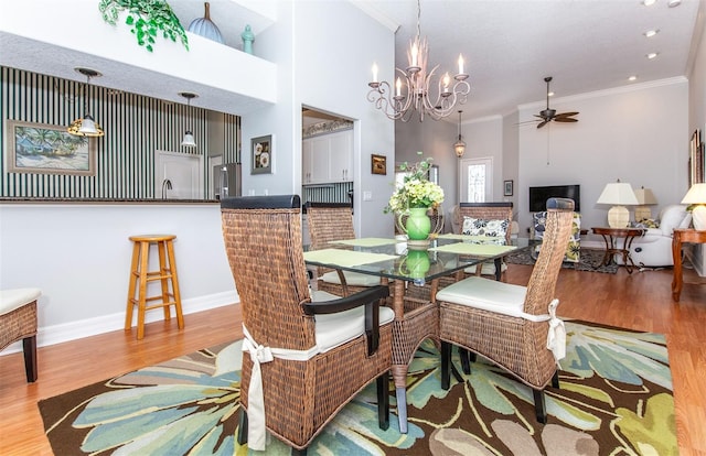 649 Crossfield Cir Unit 10, Venice, FL 34293 - dining space with ornamental molding, wood finished floors, a ceiling fan, baseboards, and a chandelier