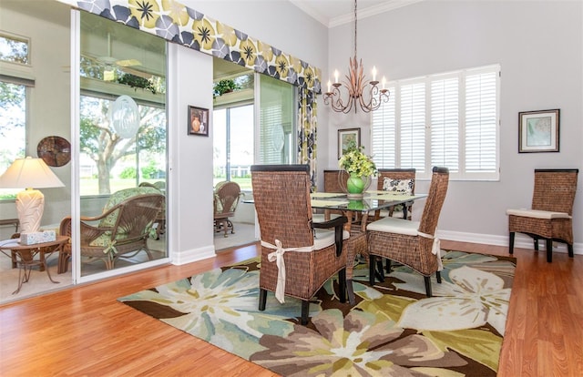 649 Crossfield Cir Unit 10, Venice, FL 34293 - dining area with a chandelier, crown molding, wood finished floors, plenty of natural light, and baseboards