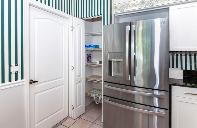 649 Crossfield Cir Unit 10, Venice, FL 34293 - kitchen featuring stainless steel fridge, light tile patterned floors, white cabinetry, and open shelves