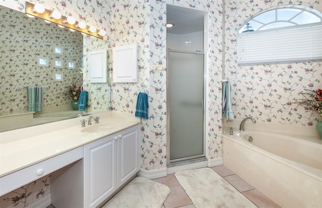 649 Crossfield Cir Unit 10, Venice, FL 34293 - full bathroom featuring wallpapered walls, tile patterned flooring, a stall shower, vanity, and a garden tub