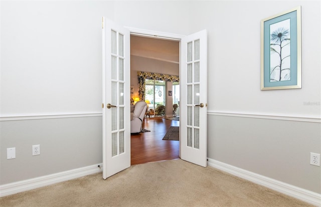 649 Crossfield Cir Unit 10, Venice, FL 34293 - hall featuring french doors, carpet floors, and baseboards