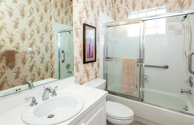 649 Crossfield Cir Unit 10, Venice, FL 34293 - full bathroom with wallpapered walls, toilet, shower / bath combination with glass door, and vanity