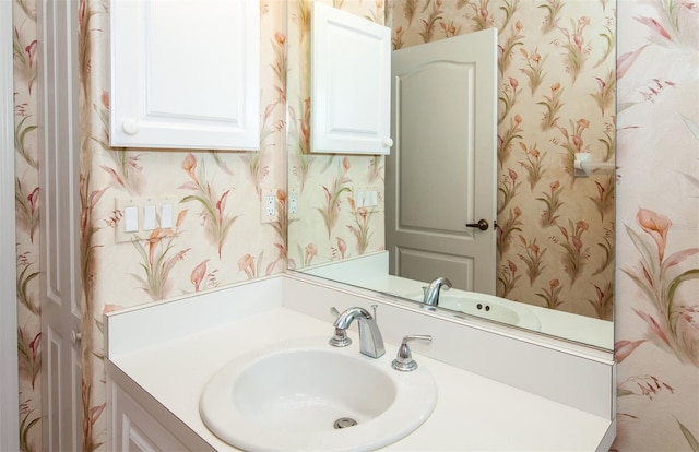 649 Crossfield Cir Unit 10, Venice, FL 34293 - bathroom featuring wallpapered walls and vanity