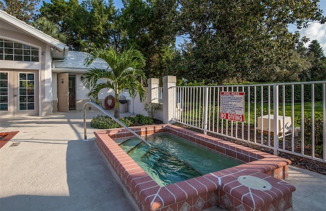 649 Crossfield Cir Unit 10, Venice, FL 34293 - view of swimming pool featuring a hot tub, fence, and a patio