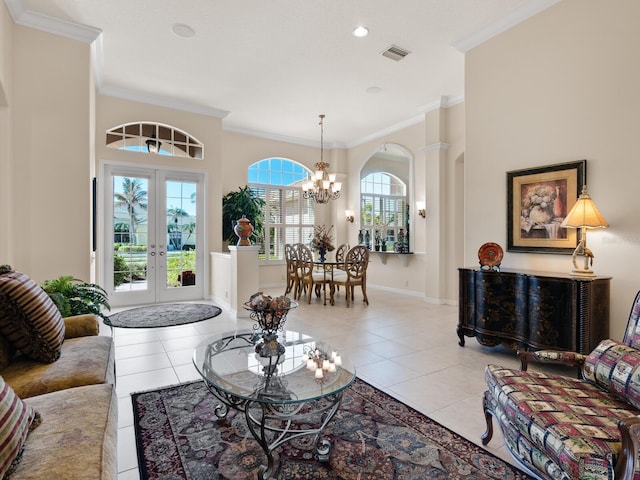 entryway with light tile patterned flooring, ornamental molding, and french doors