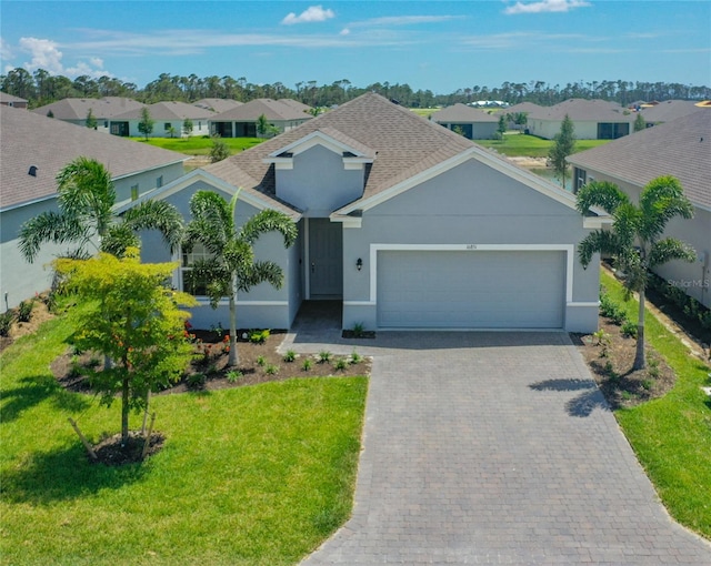 view of front of house with a front lawn and a garage