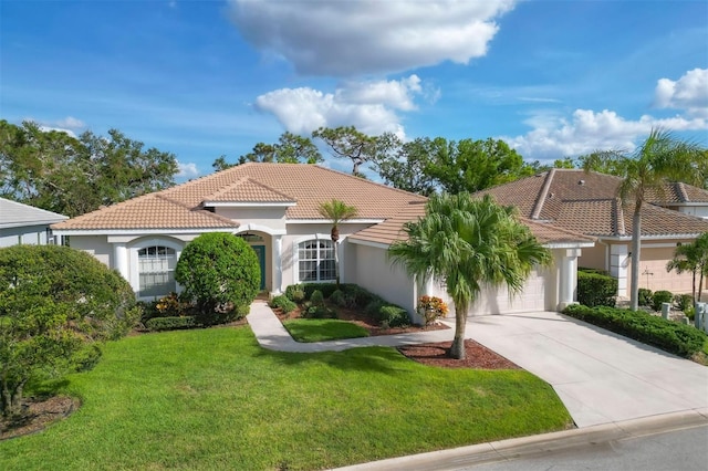 mediterranean / spanish-style home featuring a garage and a front lawn