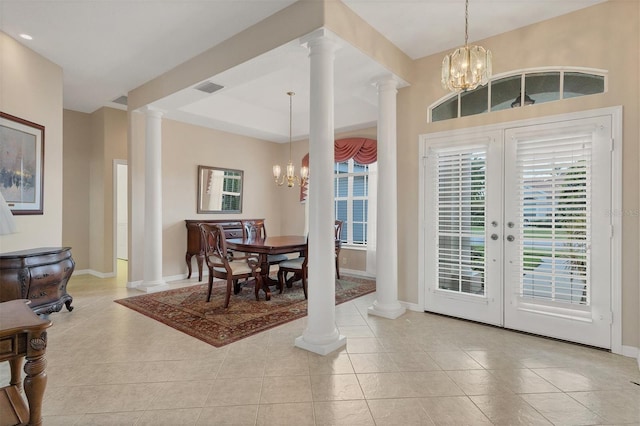 dining area featuring french doors, light tile patterned floors, and a notable chandelier