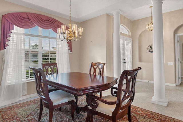 dining room with decorative columns, a wealth of natural light, and an inviting chandelier