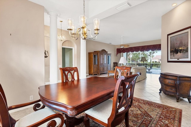 dining room featuring decorative columns and light tile patterned flooring