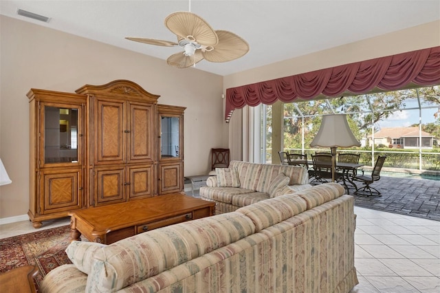 living room featuring light tile patterned floors and ceiling fan