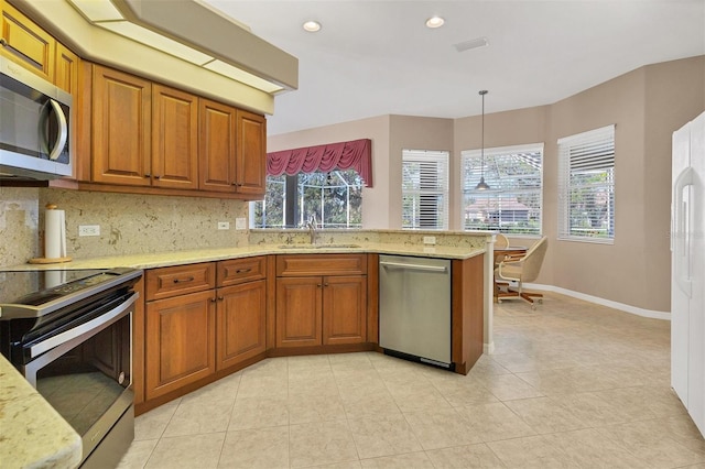 kitchen featuring backsplash, stainless steel appliances, sink, light tile patterned floors, and decorative light fixtures