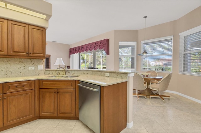 kitchen featuring dishwasher, hanging light fixtures, plenty of natural light, and sink