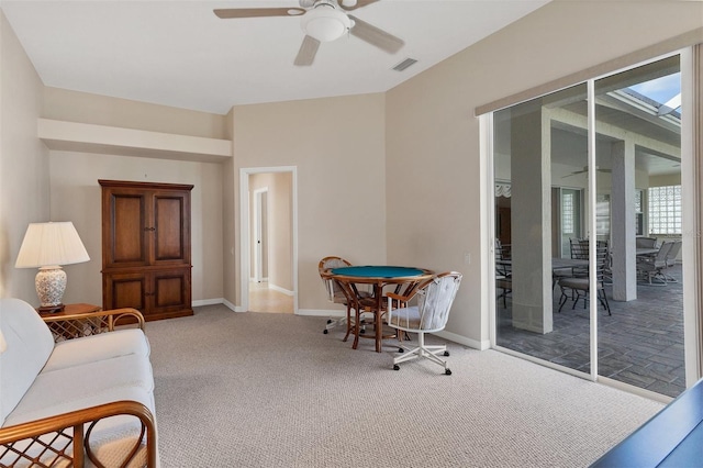 carpeted living room featuring ceiling fan and plenty of natural light