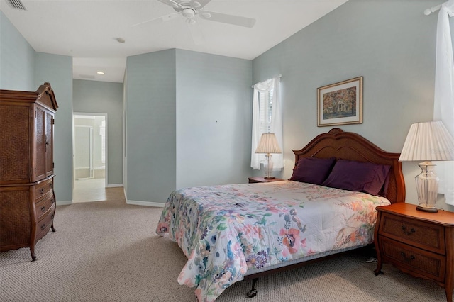 bedroom with ensuite bath, ceiling fan, and light carpet