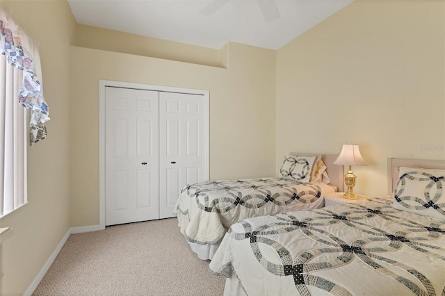 carpeted bedroom featuring a closet and ceiling fan