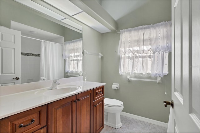 bathroom featuring toilet, vanity, tile patterned floors, and a wealth of natural light