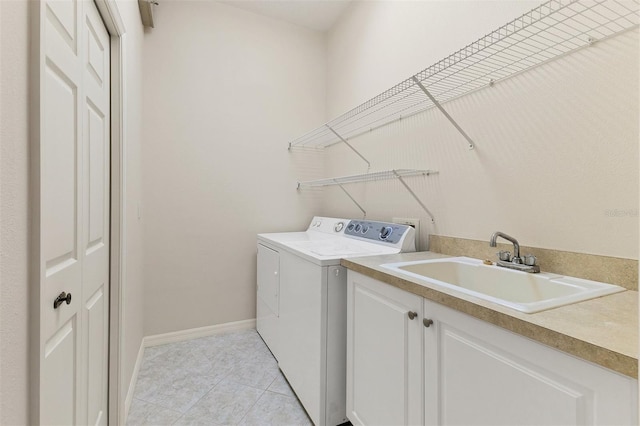 washroom with washer and dryer, cabinets, light tile patterned floors, and sink