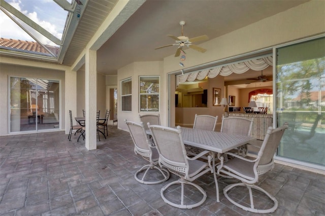 view of patio / terrace with ceiling fan and a lanai